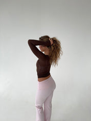 Brown wrap top with pink pants side pose