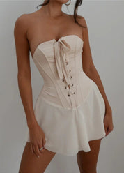 Beige corset dress front view with hands at sides