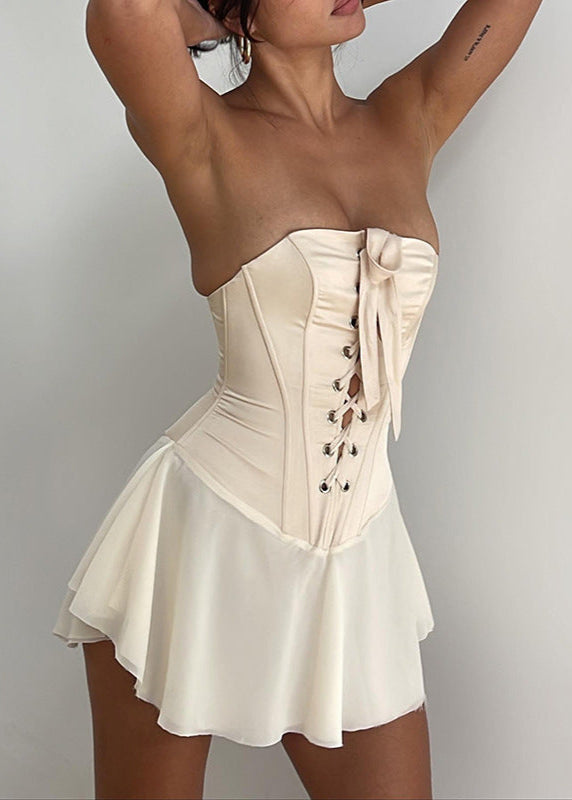 Beige corset dress front view with hands raised