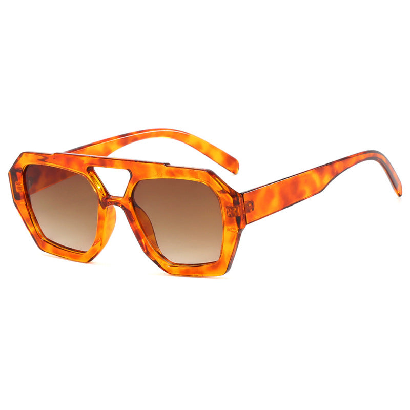 Geometric sunglasses yellow-brown front view close-up