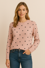 Pink knit sweater with black polka dots front view