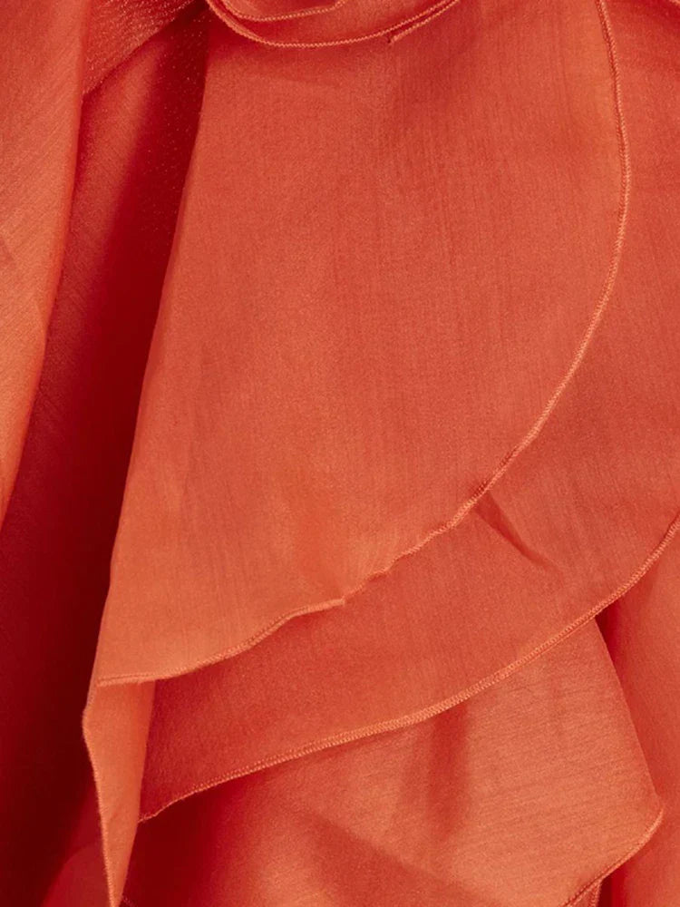 Close-up of orange maxi dress ruffles, showcasing texture and detail