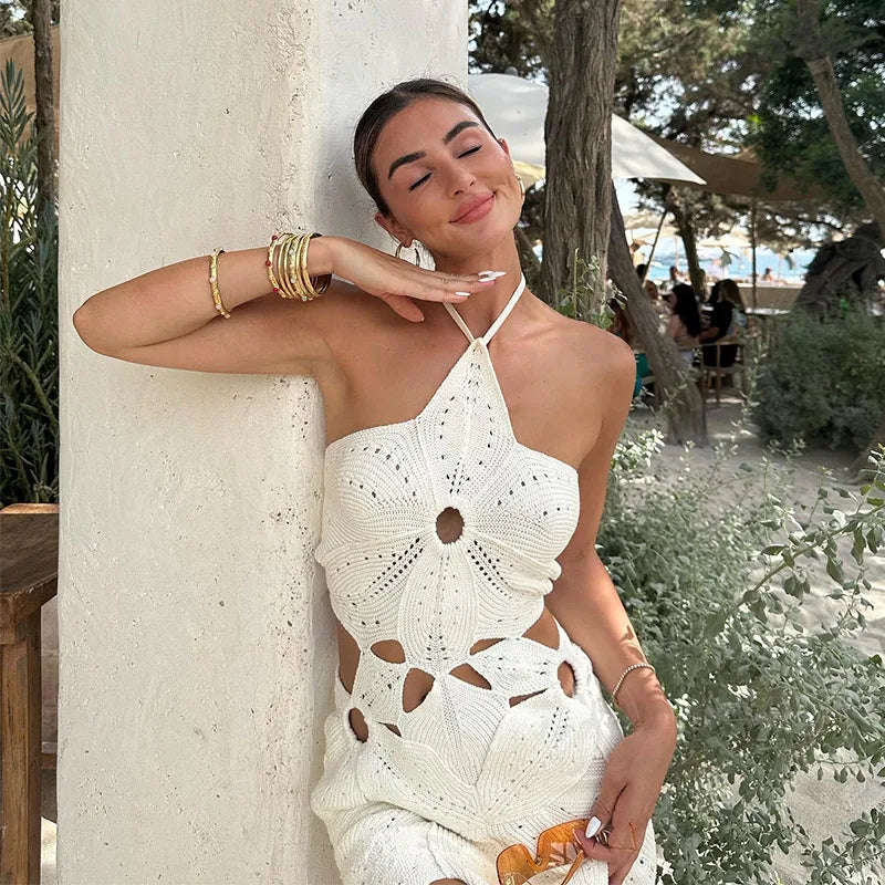 White crochet mini dress with floral pattern leaning pose