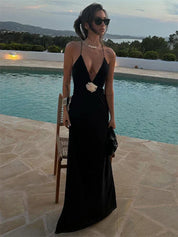 Black maxi dress with deep V-neck and white bow side view by pool
