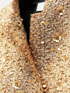 Jas goud met pailletten en knopen detail