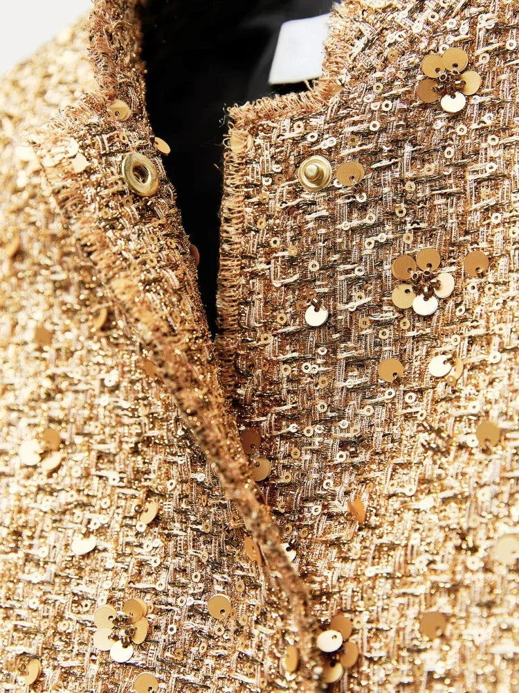 Jas goud met pailletten en knopen detail