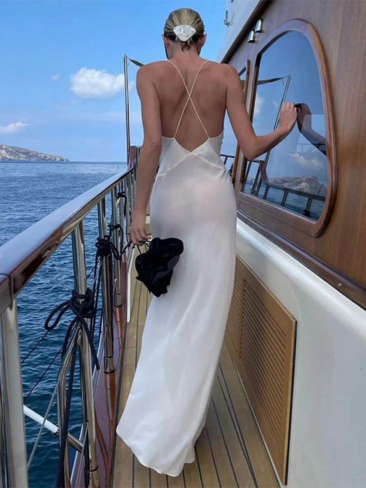 White maxi dress with deep V-neck and open back on yacht