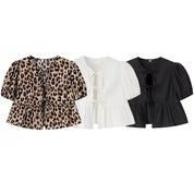 Blouses in leopard print, white, and black puff sleeves comparison