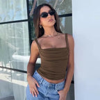 Brown tank top with ruched detailing, worn with jeans, side profile.