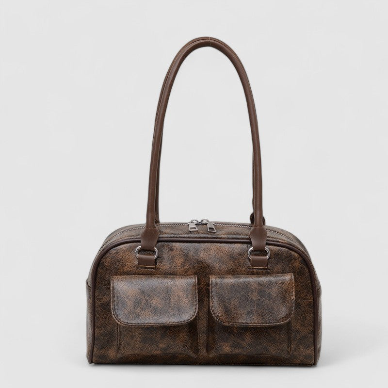 Brown leather shoulder bag with front pockets, front view