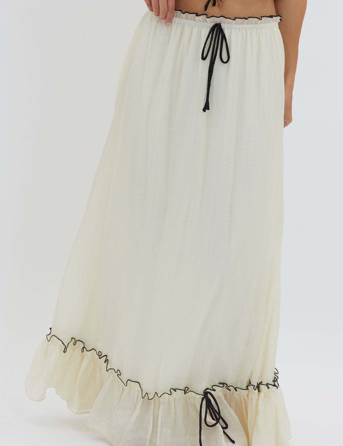 Cream ruffled skirt detail view