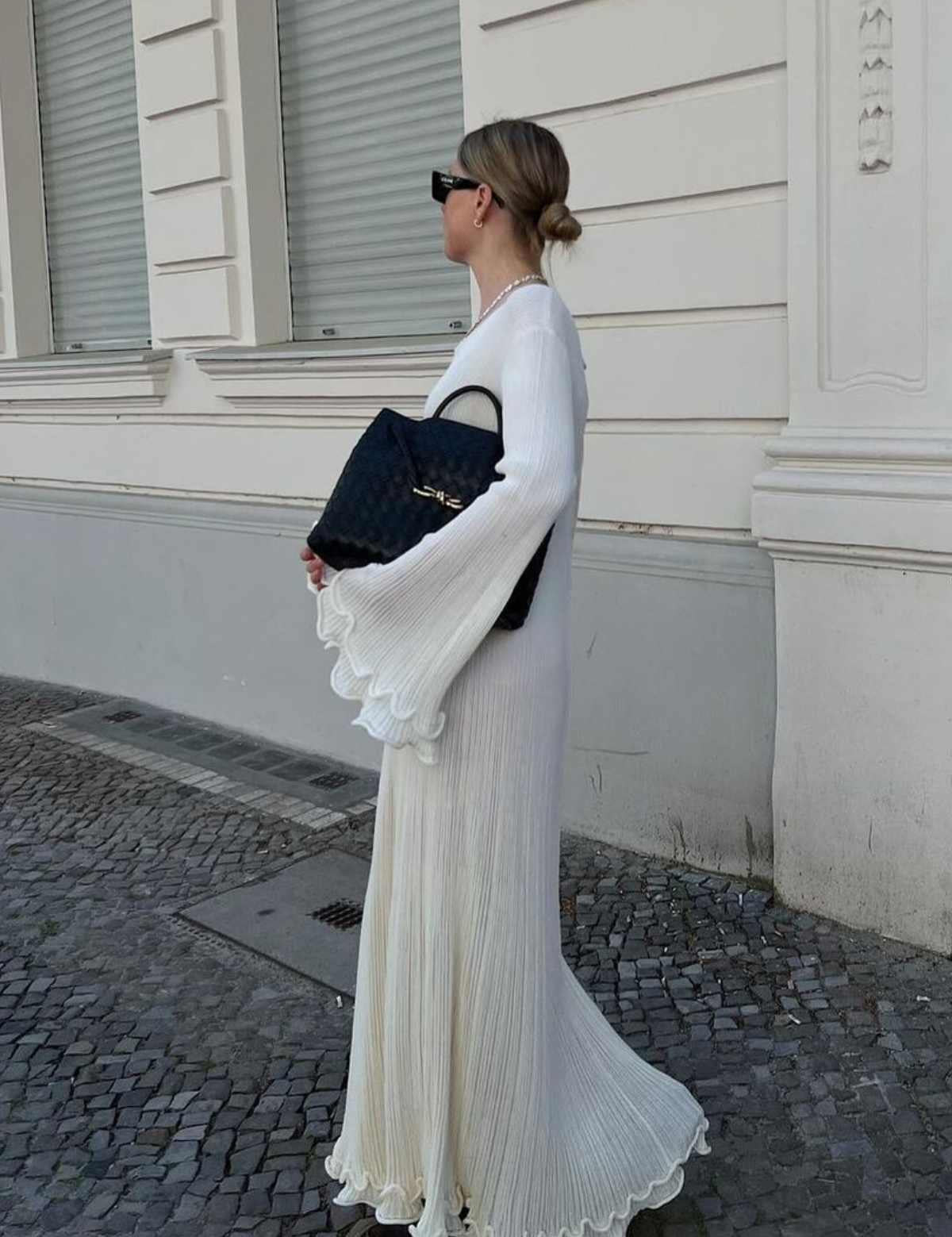 White maxi dress with ruffles and pleats, side view