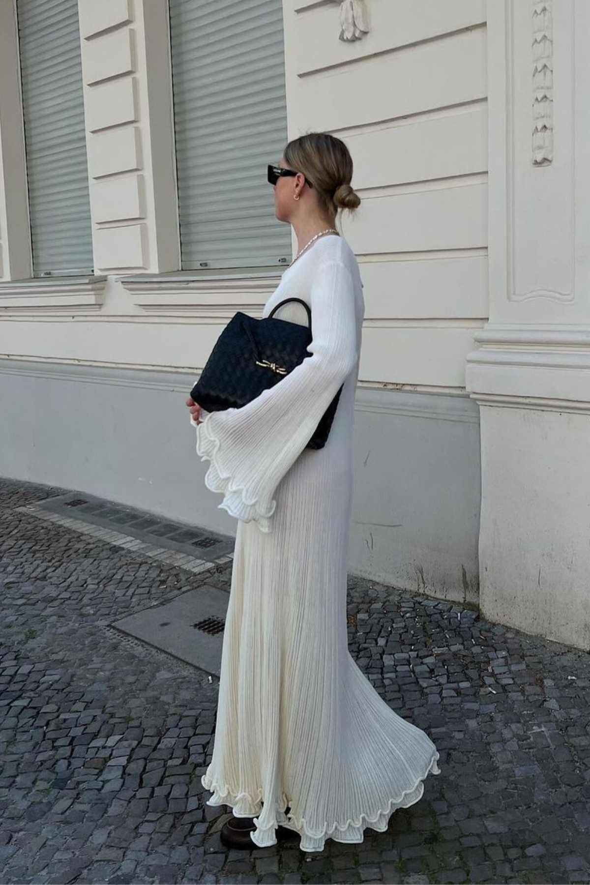 White maxi dress with ruffles and pleats, side view