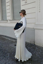 White maxi dress with ruffles and pleats, side view