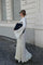 White maxi dress with ruffles and pleats, side view