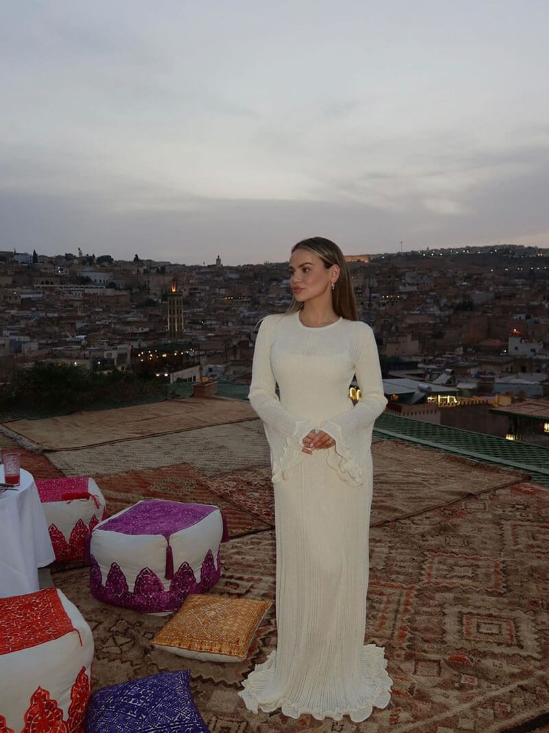 White maxi dress with ruffles and pleats, front view on rooftop