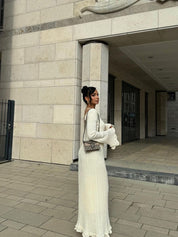 White maxi dress with ruffles and pleats, back view