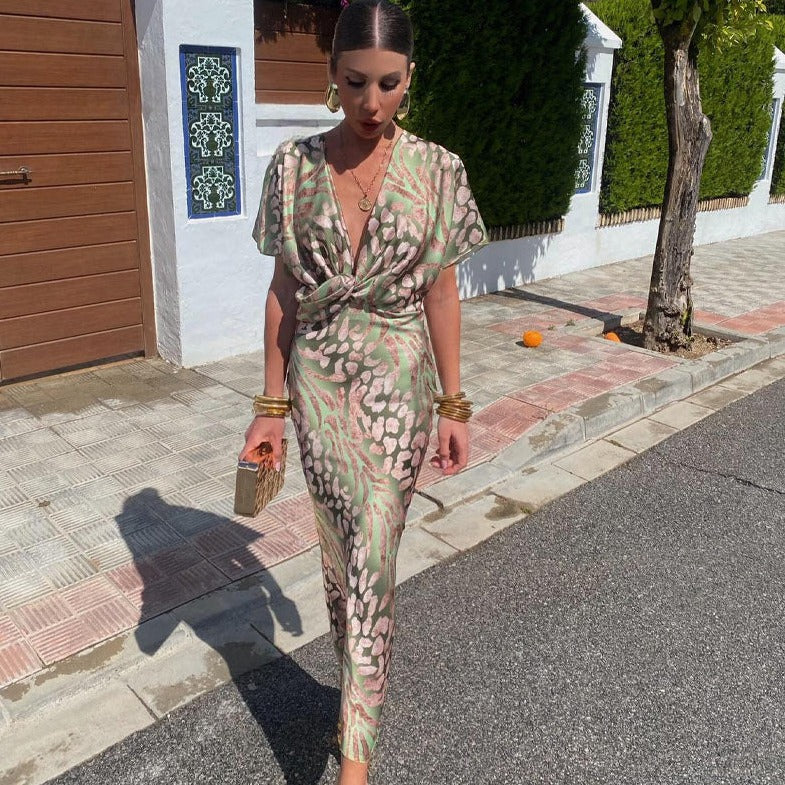 Dress with twist detail in green and pink pattern, front view