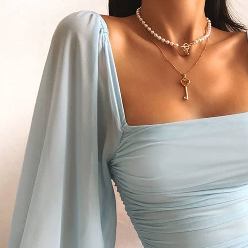 Light blue mini dress with ruched detailing close-up neck view
