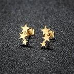 Gold star earrings angled view