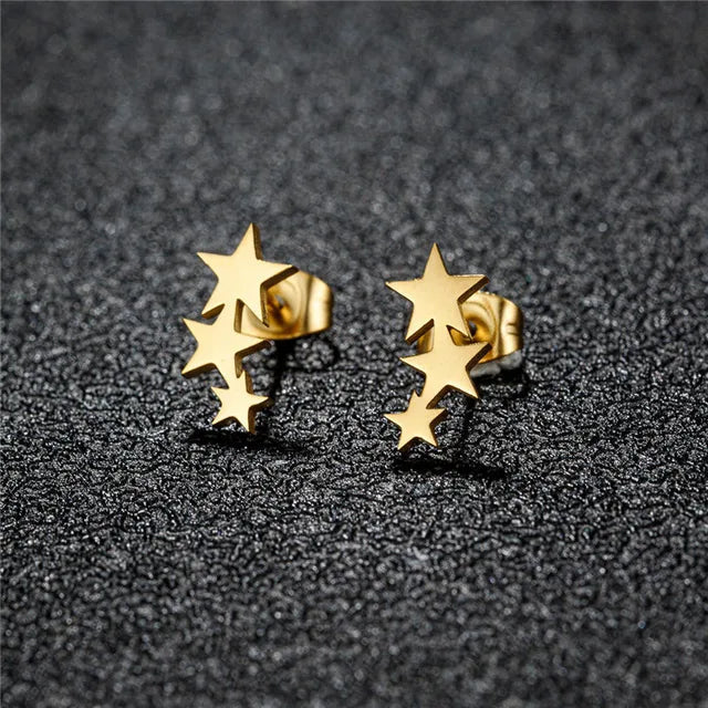 Gold star earrings angled view