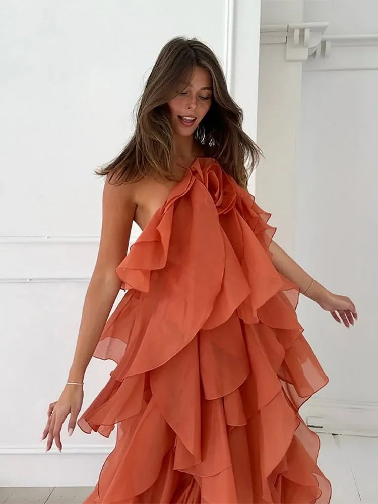 Orange maxi dress with ruffles, side view showcasing flow and movement