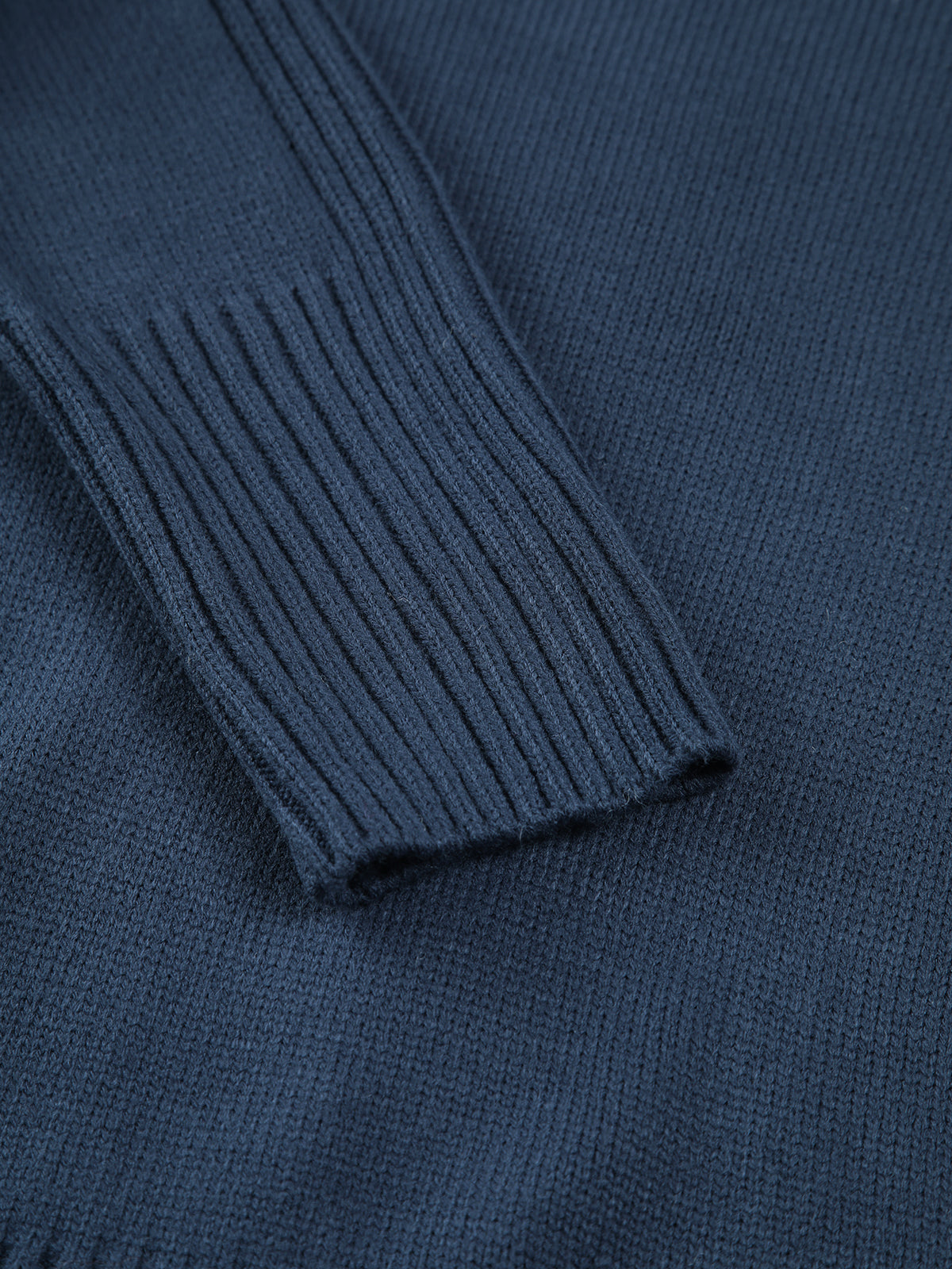 Close-up of marine blue ribbed turtleneck sweater neckline detail