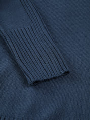 Close-up of marine blue ribbed turtleneck sweater neckline detail