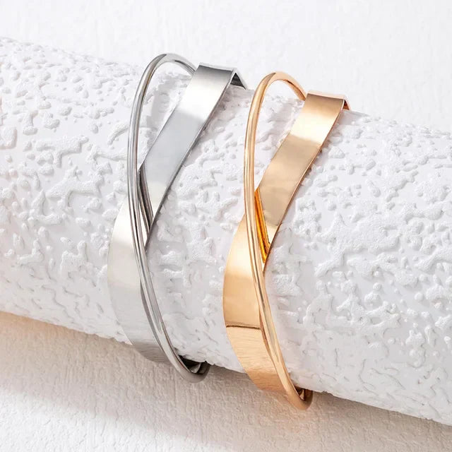 Silver and gold layered armbands, stacked on wrist