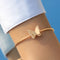 Gold armband with butterfly charm, front view