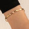 Gold armband with wave detail, side view