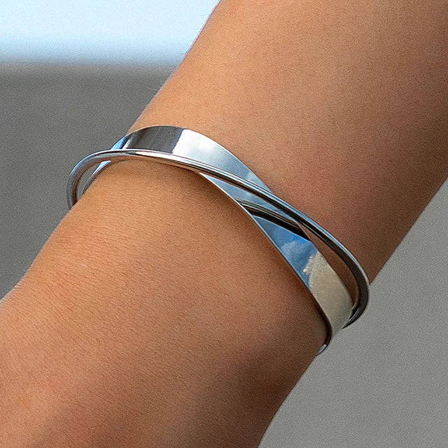 Silver armband with layered metal design, front view