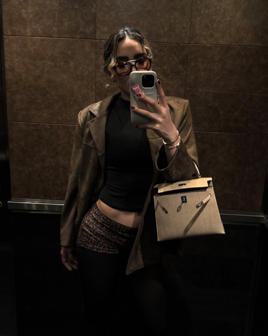 Brown suede-look blazer mirror selfie with model indoors