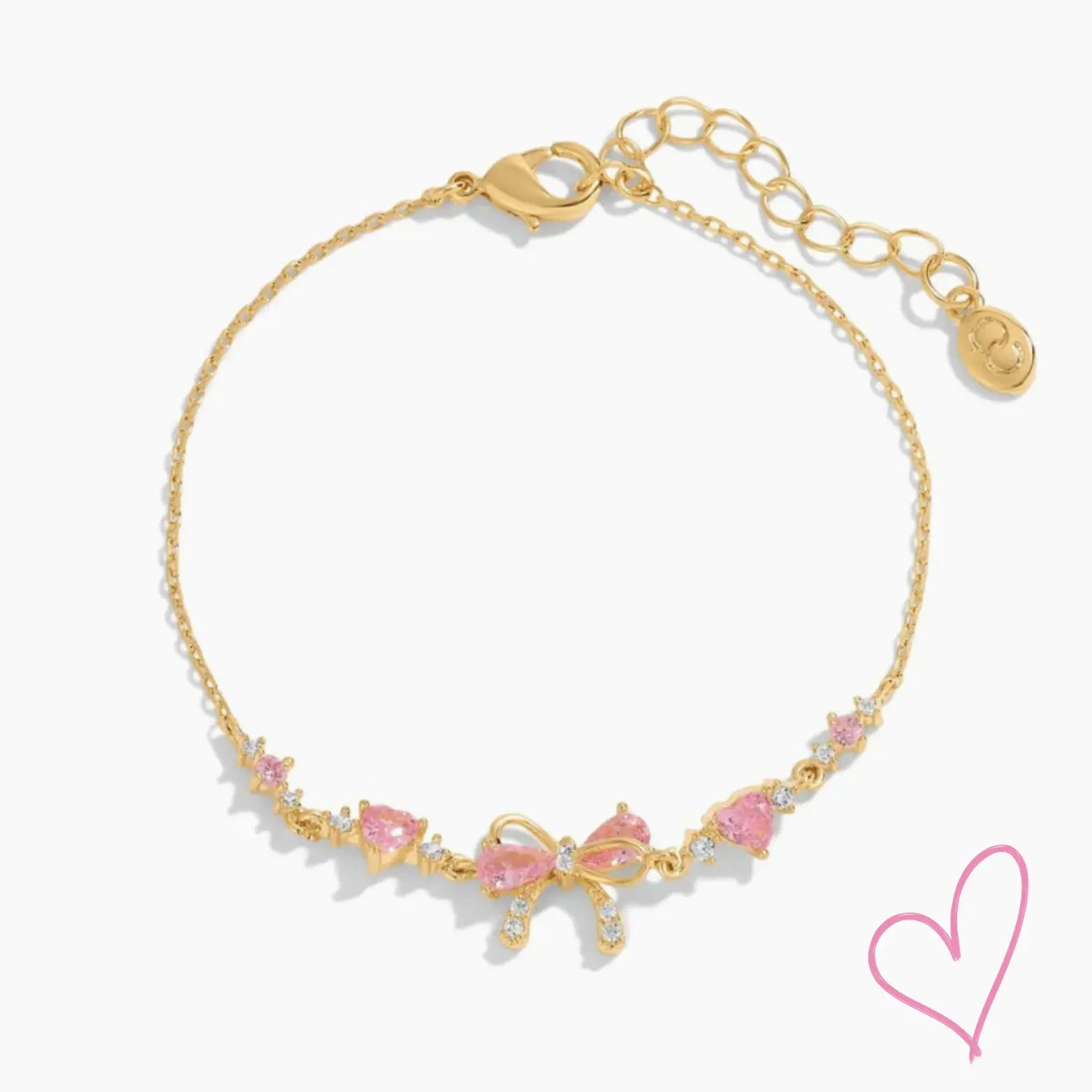 Gold necklace with pink heart stones and bow detail, front view