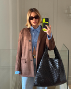 Brown suede-look blazer mirror selfie with model indoors