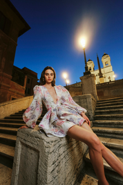 Summer dress with floral print and bell sleeves worn outdoors