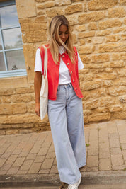 Red sleeveless gilet with buttons side view