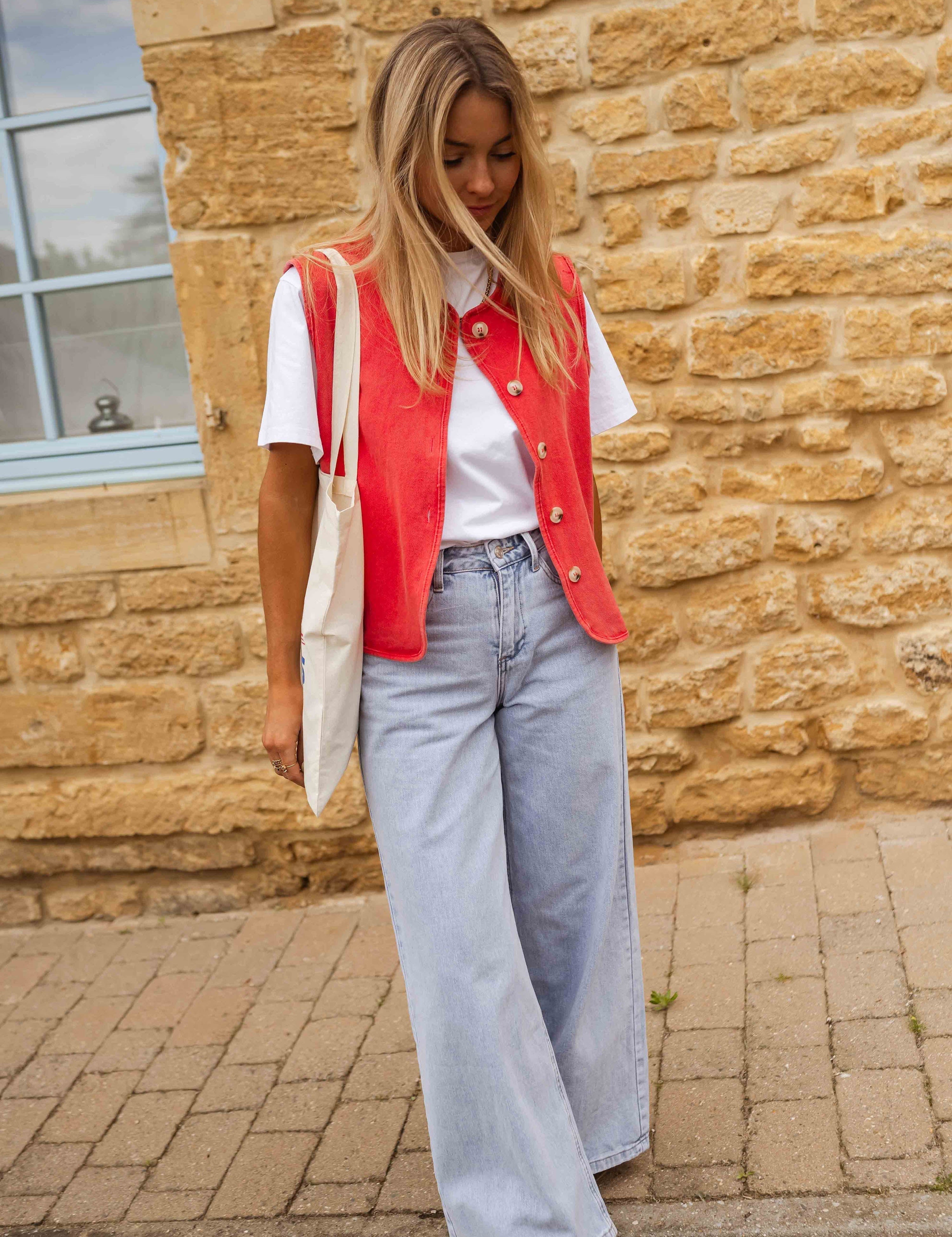 Red sleeveless gilet with buttons side view