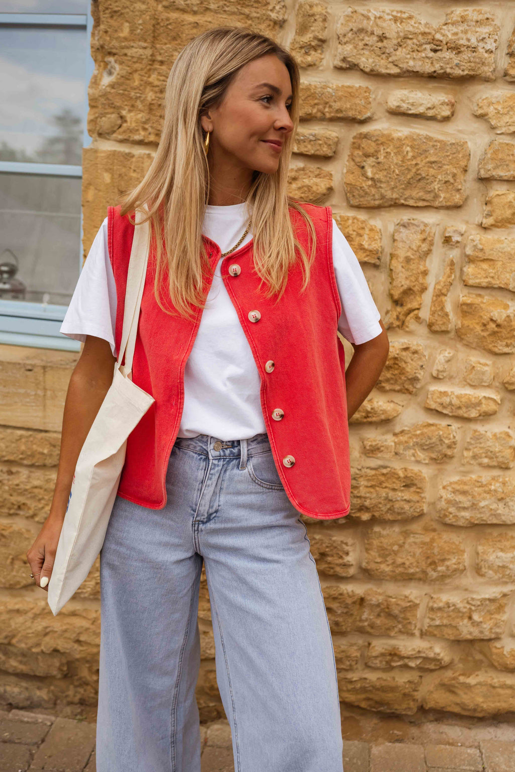 Red sleeveless gilet with buttons front view