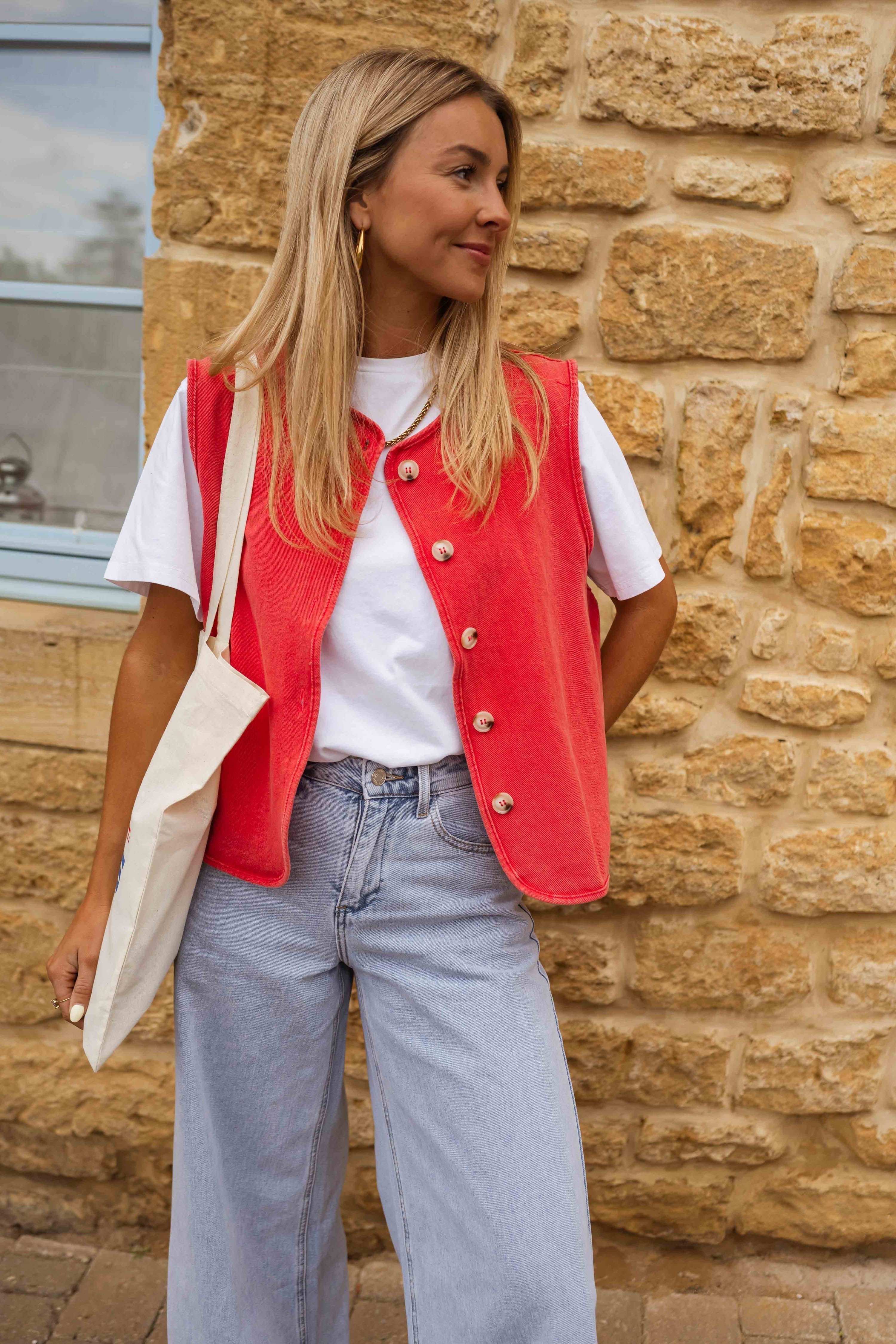 Red sleeveless gilet with buttons front view