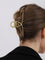 Gold metal hair clamp with twisted texture, side view on hair