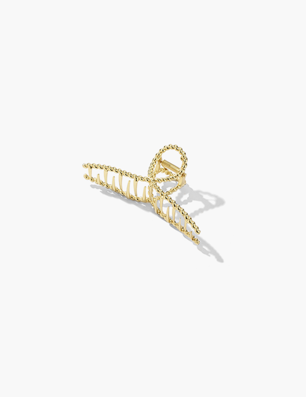 Gold metal hair clamp with twisted texture, front view isolated