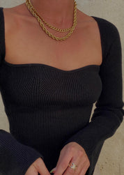 Black ribbed bodysuit close-up detail on neckline