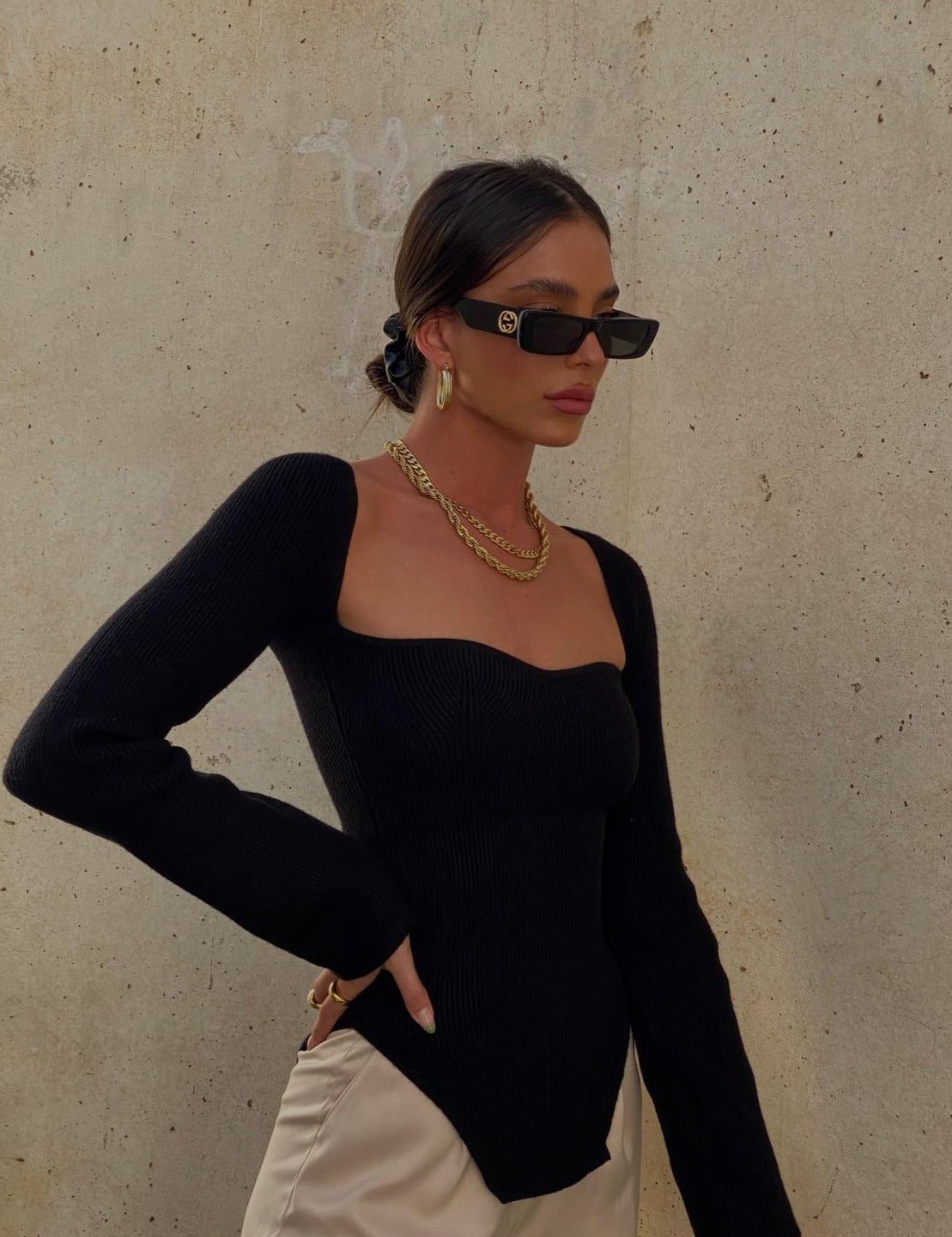 Black ribbed bodysuit front view with gold jewelry