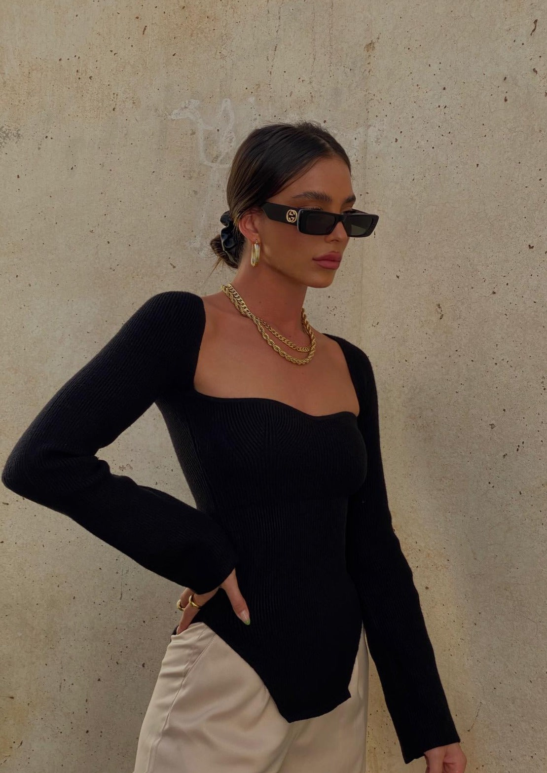 Black ribbed bodysuit front view with gold jewelry