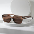 Sunglasses brown translucent square frame with metal temple accents front view