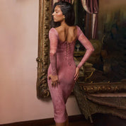 Pink lace midi dress back view with ornate background