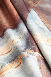 Close-up of patchwork jeans with mixed denim textures and colors