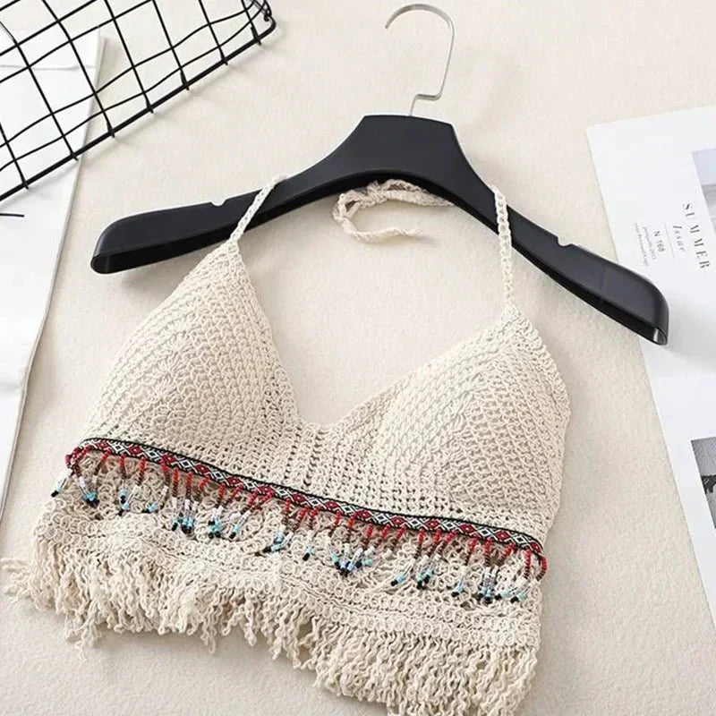 Cream crochet halter top with tassels and beaded trim, front view on hanger