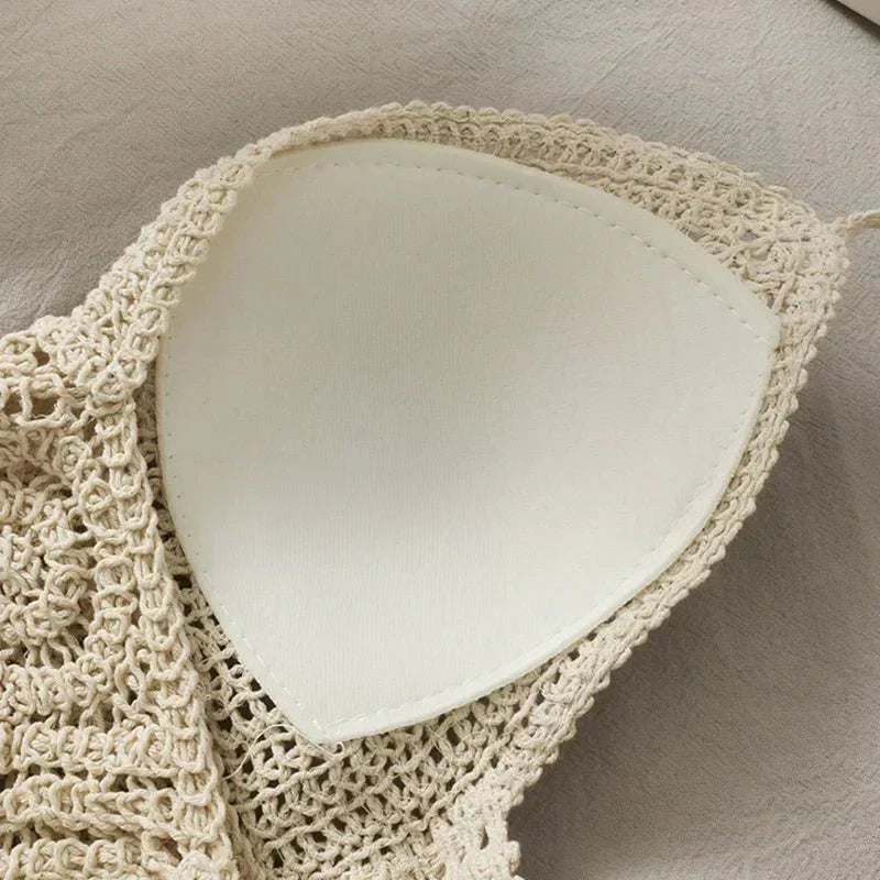 Close-up of cream crochet halter top with tassels, focusing on fabric texture